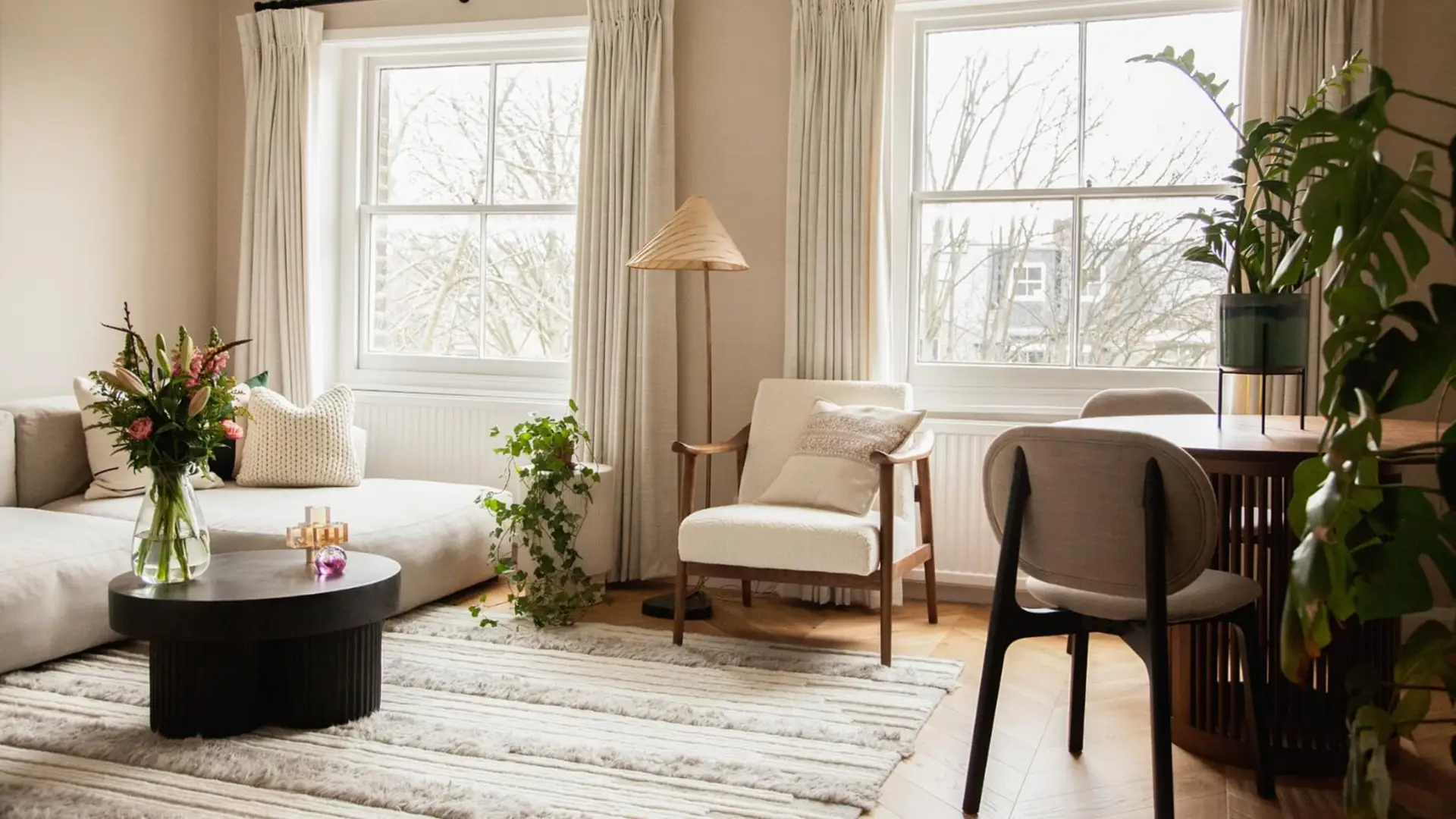 Biophilic Design with Wren Be-Kin Handwoven Natural Wool Rug Handtufted in Lounge with Cream Sofa and Round Dining Set